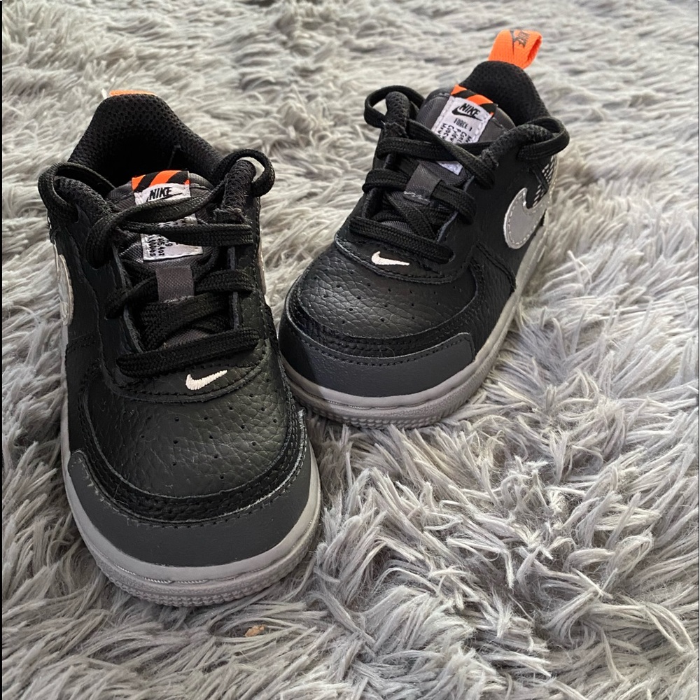Black grey and orange size 7 on toddler NIKES.